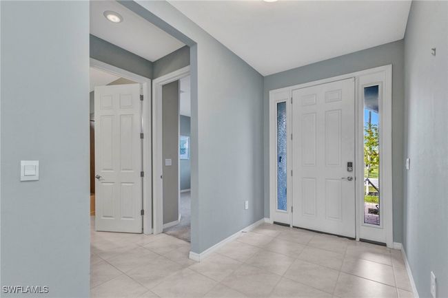 Entrance foyer featuring light tile patterned floors and baseboards | Image 10