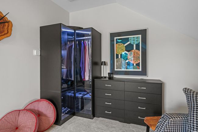 Carpeted bedroom with lofted ceiling and a closet | Image 27