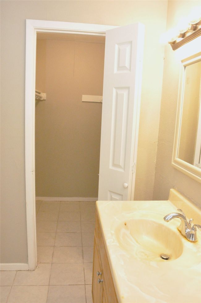primary bathroom with tile patterned flooring, vanity, and baseboards | Image 18