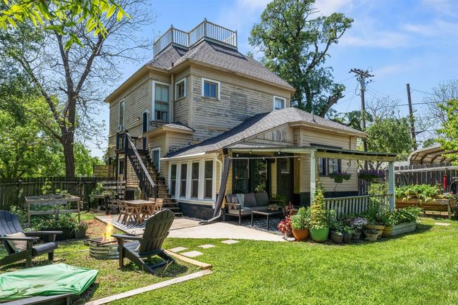 Back of house featuring a balcony, roof with shingles, an outdoor living space, a patio area, and stairway | Image 33
