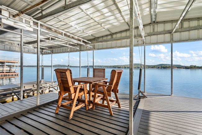 Dock area with a water view and boat lift | Image 5