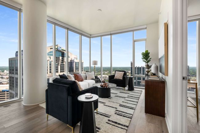 The luxurious and comfortable living room beckons you to relax and unwind as you become mesmerized by the stunning vistas of the city. | Image 22