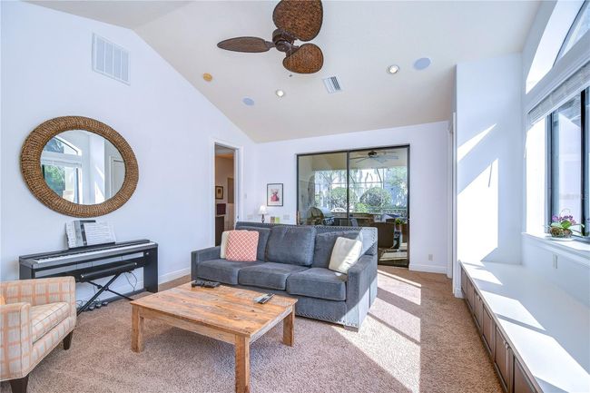 Step into this inviting space bathed in natural light, defined by its vaulted ceilings and ample natural lighting. | Image 18