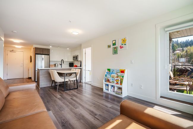 Living area featuring dark wood-style flooring and baseboards | Image 6