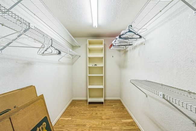 Walk in closet featuring light wood finished floors | Image 34