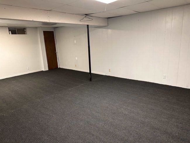 Finished below grade area with dark colored carpet | Image 13