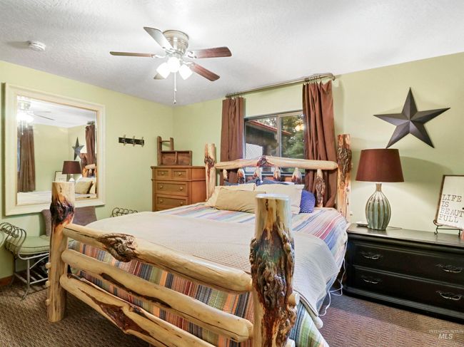 Carpeted bedroom featuring a textured ceiling and a ceiling fan | Image 30