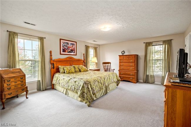 Carpeted bedroom with multiple windows and a textured ceiling | Image 20