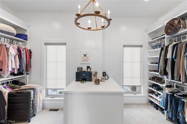 Spacious closet featuring light carpet and a chandelier | Image 20