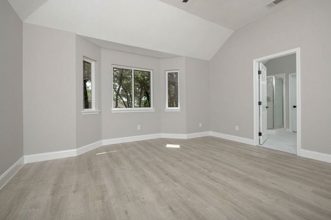 Unfurnished room featuring vaulted ceiling and light wood-type flooring | Image 29