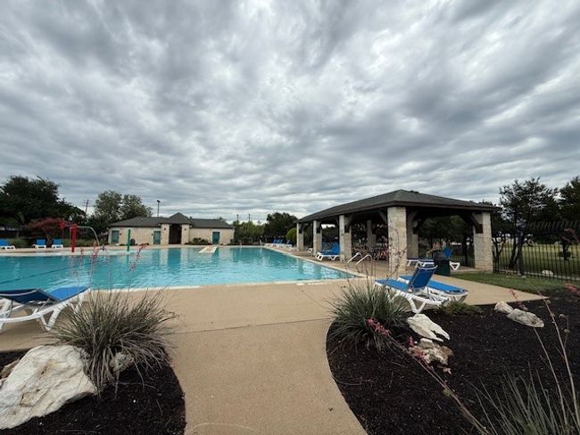 Community pool with a gazebo and a patio directly behind townhouse | Image 35