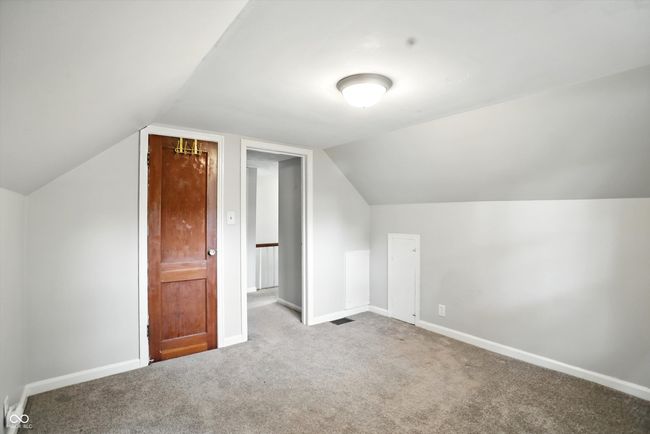 additional living space with carpet floors and lofted ceiling | Image 36