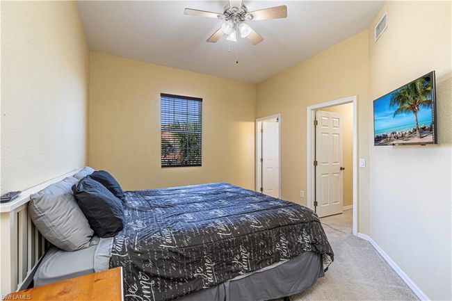 Bedroom featuring visible vents, ceiling fan, carpet, and baseboards | Image 12