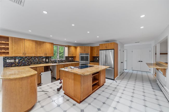 Kitchen with open shelves, freestanding refrigerator, a baseboard radiator, light flooring, and recessed lighting | Image 12