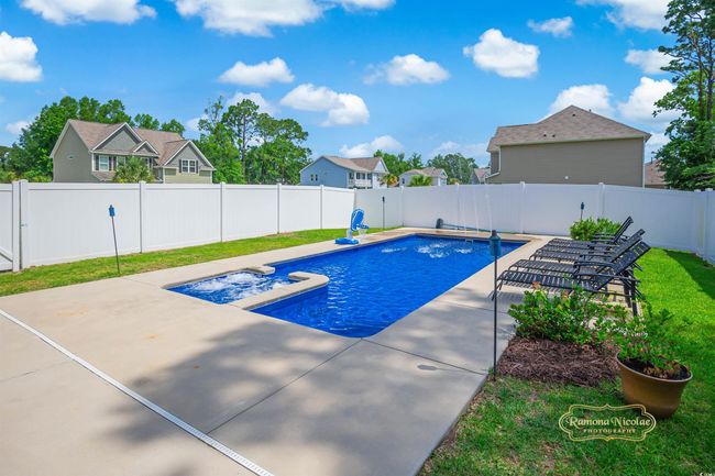 View of swimming pool featuring a patio area and a residential view | Image 5