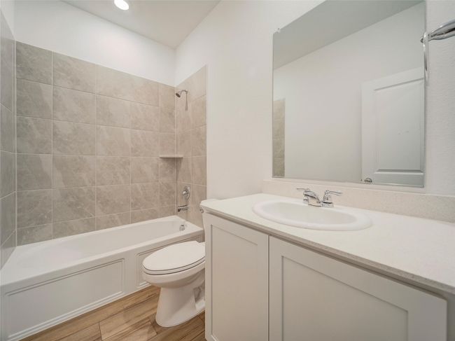 Bathroom with toilet, vanity, shower / bathtub combination, and wood finished floors | Image 32