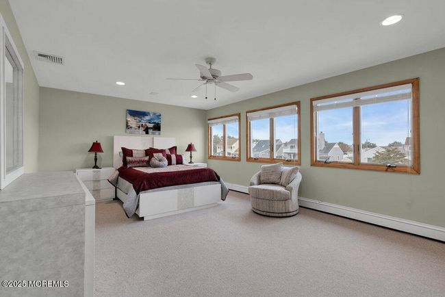 Spacious primary bedroom with lots of light and water views | Image 27