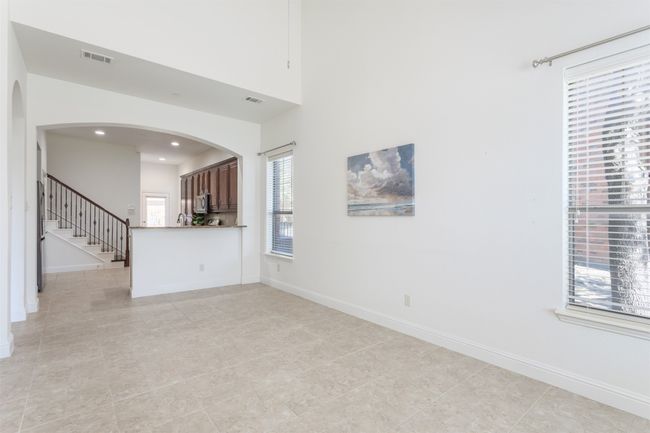 Unfurnished living room with visible vents, recessed lighting, arched walkways, baseboards, and stairs | Image 4