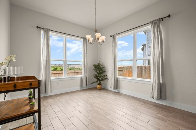 Unfurnished dining area with a chandelier, plenty of natural light, and light wood-type flooring | Image 16