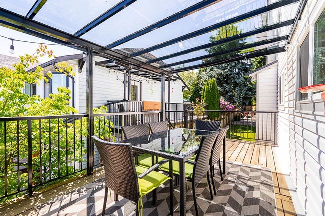 Wooden terrace with a pergola and outdoor dining area | Image 15