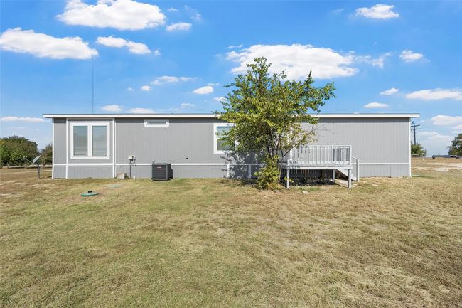 Back of house with a wooden deck and a lawn | Image 27