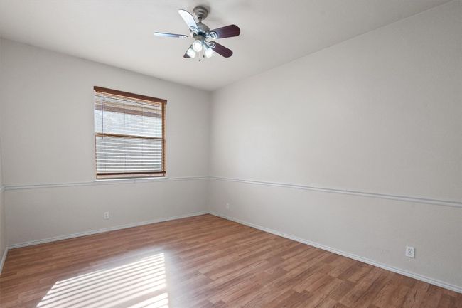 Secondary bedroom with ceiling fan | Image 26