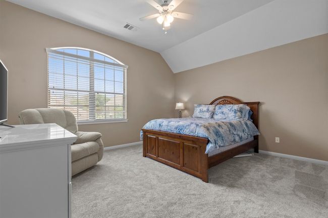 An inviting upstairs retreat, generously sized with plush carpet, a large picture window, and space to unwind in style. | Image 25
