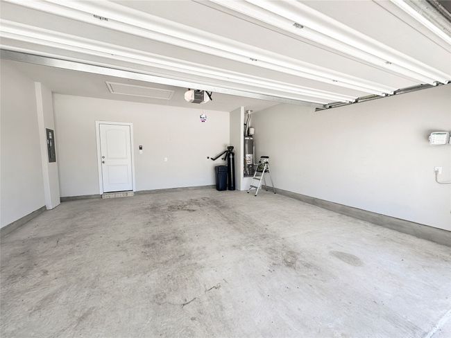 Garage with water filter, water heater, sub-panel, sprinkler control | Image 32
