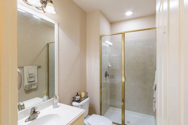 Bathroom featuring a stall shower, vanity, and toilet | Image 24