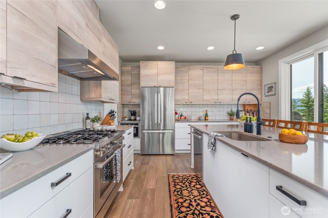 This modern, high-end kitchen is the heart of the home—featuring a spacious island perfect for gathering | Image 7