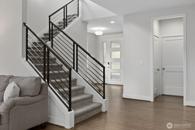 Modern design and hardwood floors create elegant living | Image 4