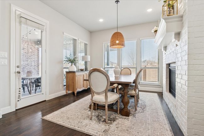 Dining area featuring a brick fireplace, baseboards, dark wood finished floors, and recessed lighting | Image 8