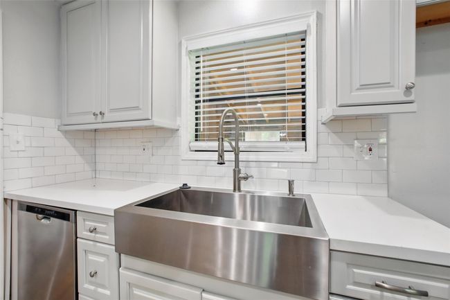 Cook, create, and gather in a kitchen designed for both style and efficiency, with a sleek stainless steel farm sink, recessed lighting, and smart storage solutions. | Image 7