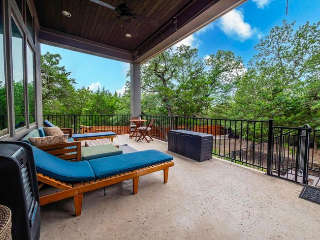 Patio / terrace with ceiling fan and view of wooded area | Image 25