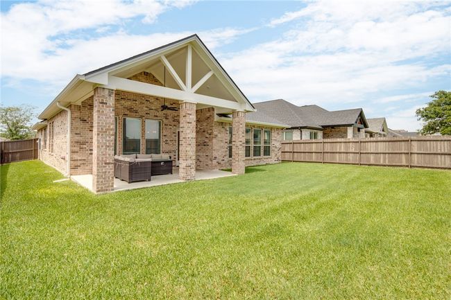 Back of property featuring an outdoor living space, a ceiling fan, a patio, and brick siding | Image 21