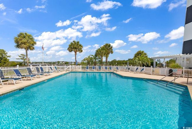 Community pool featuring a pergola, fence, and a patio area | Image 36