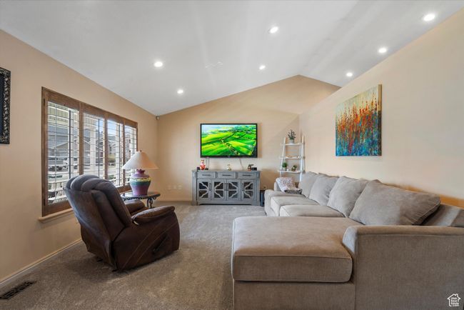 Living room with vaulted ceiling, recessed lighting, carpet flooring, baseboards, and visible vents | Image 6