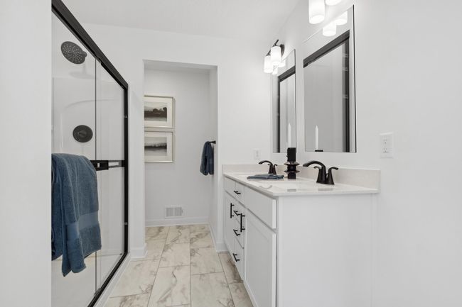 (*Photo of decorated model, actual homes colors and finishes will vary) An extension of the owner's suite, this private and spacious bath contains a double-vanity, a separate shower, and a private walk-in closet. | Image 15