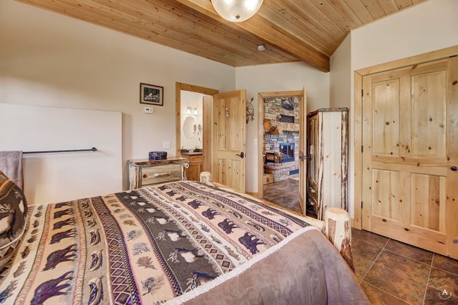 Bedroom featuring wooden ceiling and dark tile patterned flooring | Image 49