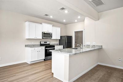 Spacious kitchen opens up to your living room. | Image 3