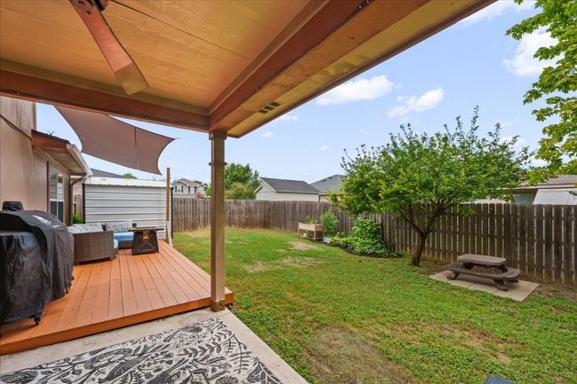 Rear covered patio and low deck. | Image 37