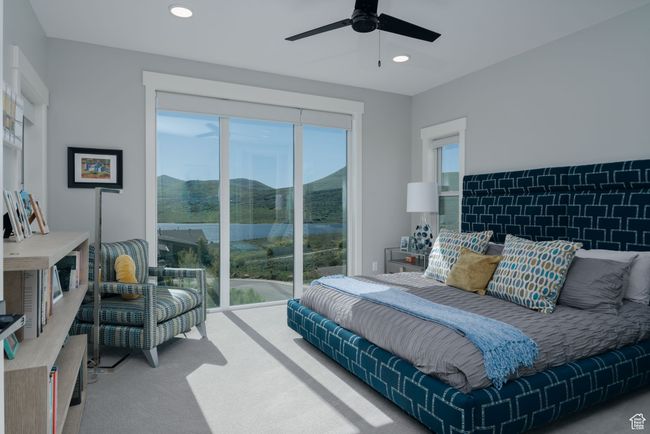 Bedroom with access to outside, carpet flooring, recessed lighting, a ceiling fan, and a water view | Image 18