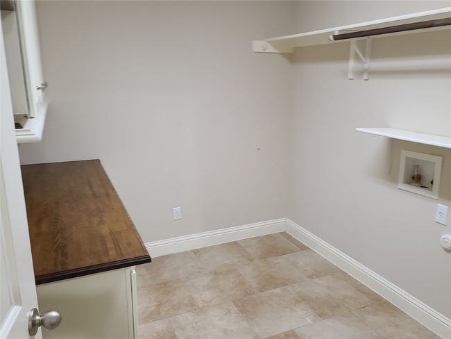 Washroom with hookup for a washing machine and baseboards | Image 24