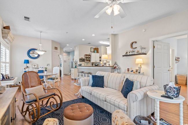 Living area with light wood-style flooring, recessed lighting, ceiling fan, and visible vents | Image 18