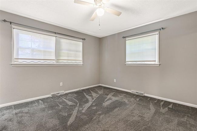Carpeted spare room with ceiling fan and baseboards | Image 55