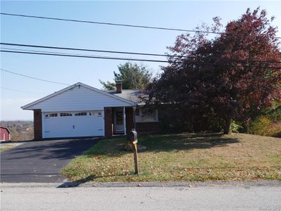 View of front of home with a front lawn and a garage | Image 2