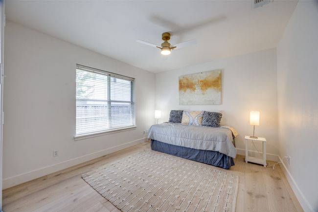 Bedroom with wood finished floors and a ceiling fan | Image 25