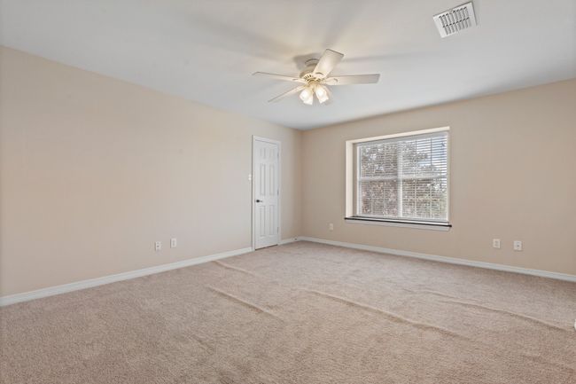 bedroom 3. Carpet is new and just needs to be stretched which didn't get done before photos but is in progress. Large window with natural light, ceiling fan, closet and private bath. | Image 33