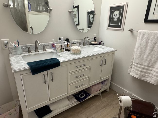 Full bath with wood finished floors and double vanity | Image 13