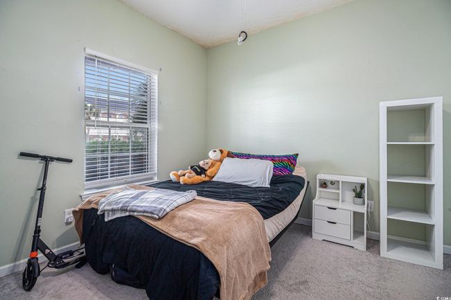 Carpeted bedroom with ceiling fan | Image 9